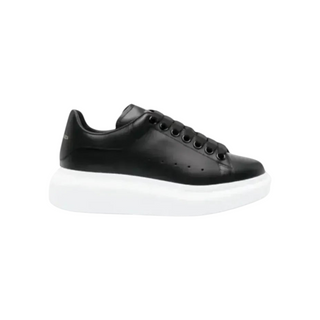 Planet Luxury Brands imzalı, siyah deri, kalın beyaz tabanlı McQueen Oversized kadın sneaker modeli.